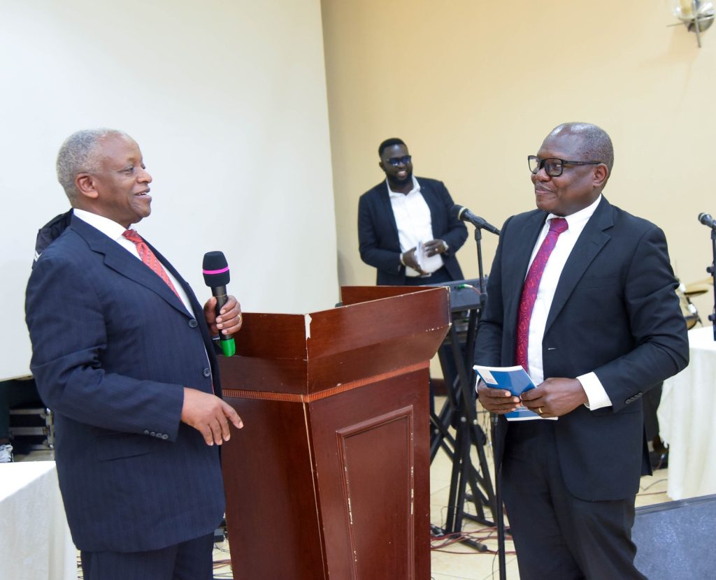 The Guest of Honour Hon.Amama Mbabazi and key note Speaker Mr David Watabi have a chat